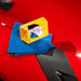 Gyeon PPF Ceramic Coating box on a blue towel with a red car surface in the background
