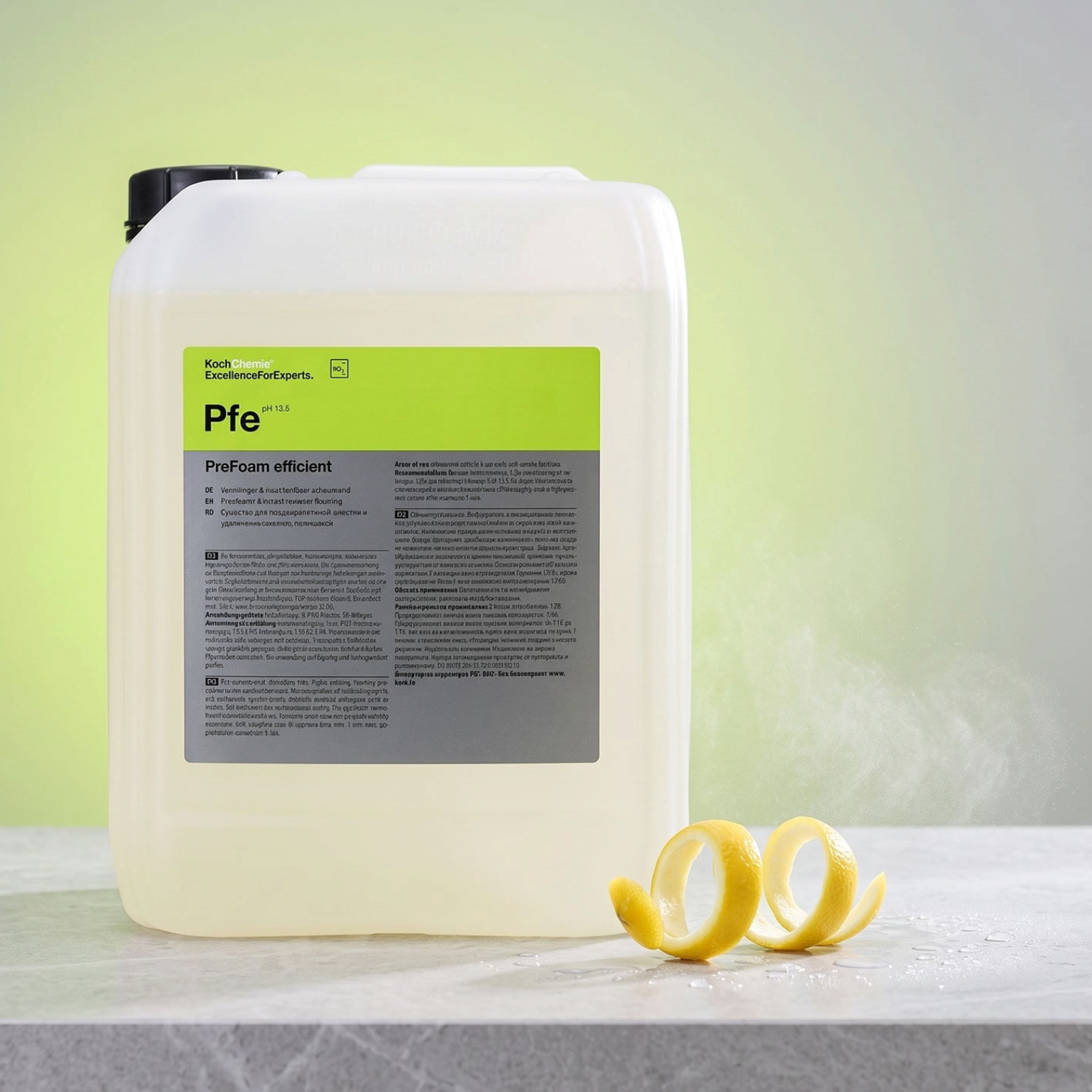 Koch-Chemie PreFoam Efficient alkaline pre-wash cleaner in a large plastic container with fresh lemon peel garnish.
