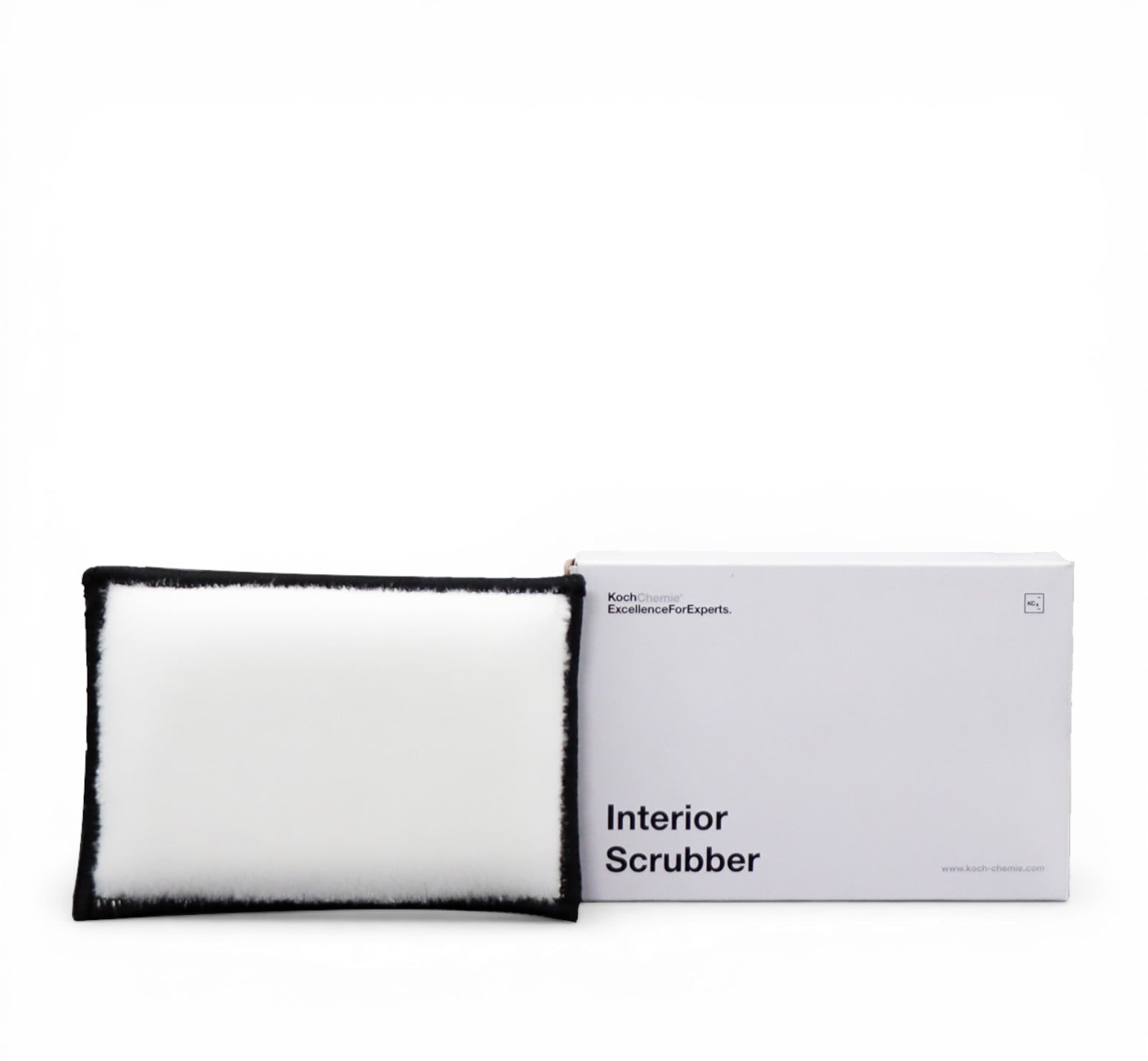A white plush interior scrubber with a black fuzzy trim, shown next to its white packaging box labeled 'Interior Scrubber' by Bath Body Works.