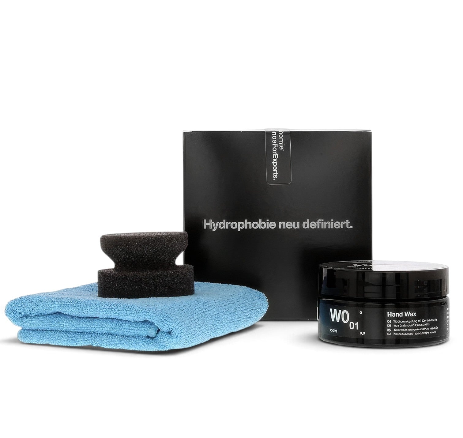 Koch-Chemie Hand Wax W0.01 kit with carnauba paste wax, applicator sponge, and blue microfibre towel.