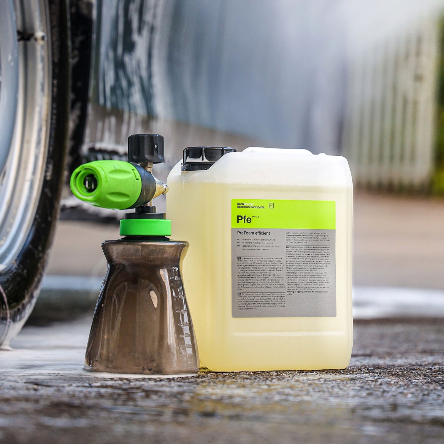 Koch-Chemie PreFoam Efficient alkaline pre-wash cleaner in a plastic container with a foam cannon on a wet surface.