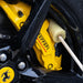 Close-up of a Ferrari brake caliper with a cleaning tool